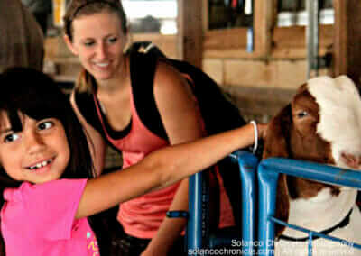 Mother and Child Petting Goat