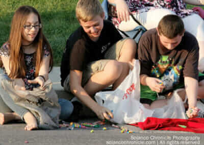 Kids Picking Up Parade Candy