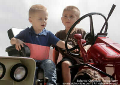 Boys Sitting on Exhibit Tractor