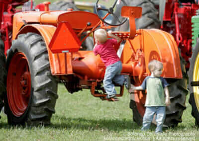 Boys Climbing on Exhibit Tractor